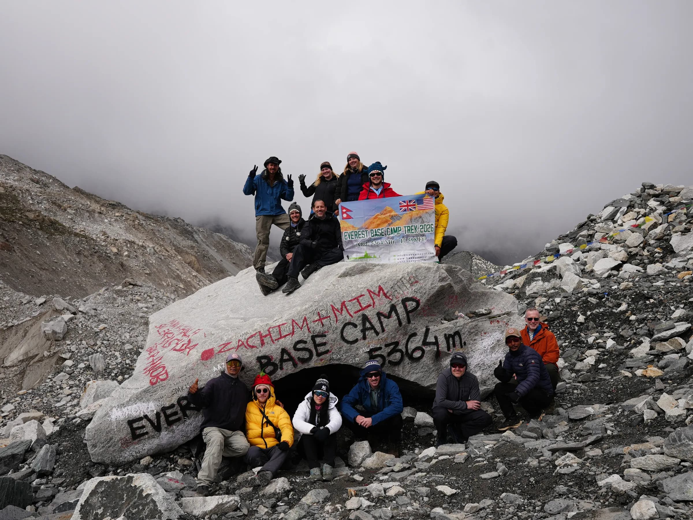 A small group of trekkers at the Everest Base Camp rock, 5,364 meters